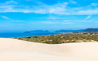 Scenic view of beach against blue sky