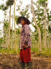 Rear view of woman standing on field