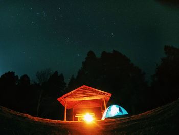 Illuminated built structure against sky at night