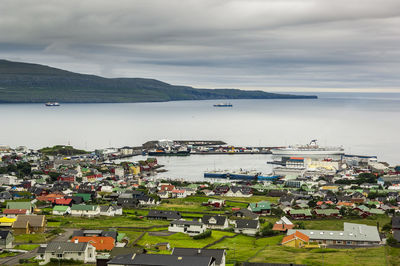 High angle view of city by sea against sky