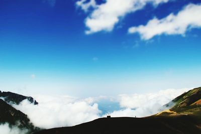 Scenic view of mountains against cloudy sky