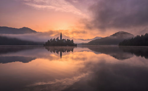 Scenic view of lake against sky during sunset