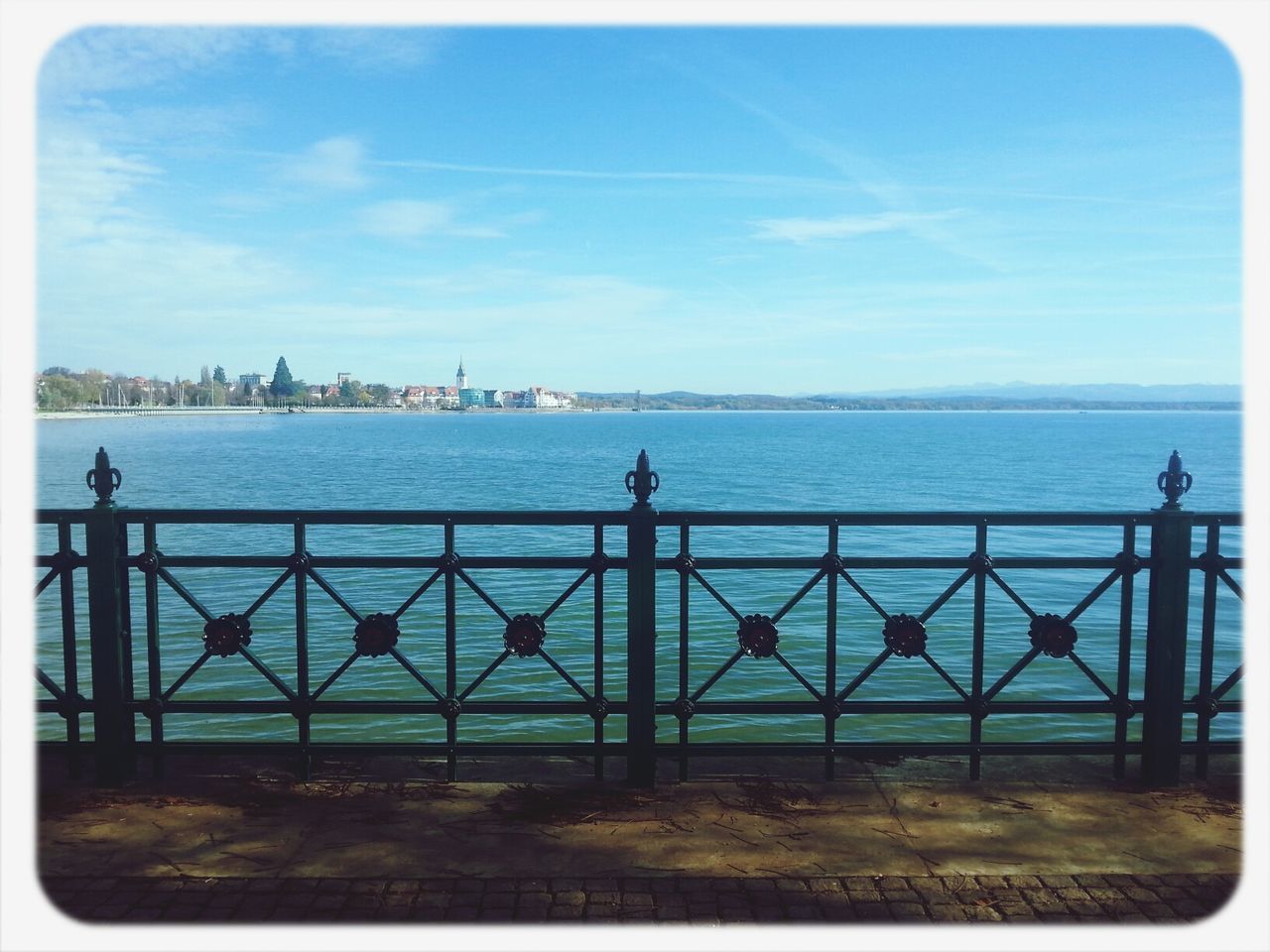 water, transfer print, sky, railing, sea, auto post production filter, built structure, pier, blue, cloud - sky, cloud, architecture, river, tranquility, tranquil scene, nature, day, scenics, incidental people, transportation