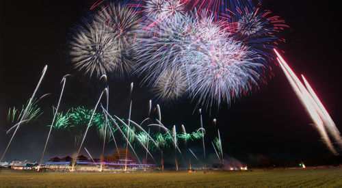 Low angle view of firework display at night