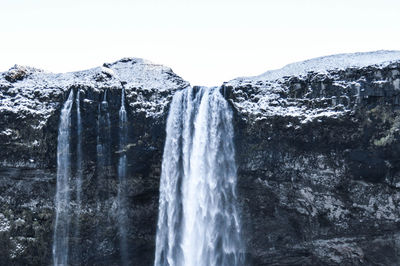 View of waterfall against clear sky