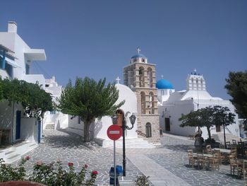 Panoramic view of trees and buildings against clear blue sky