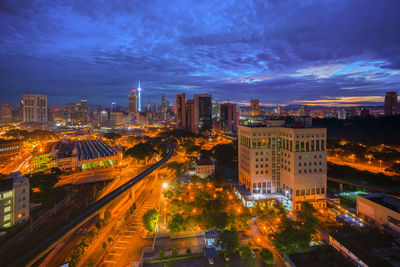 High angle view of city lit up at night