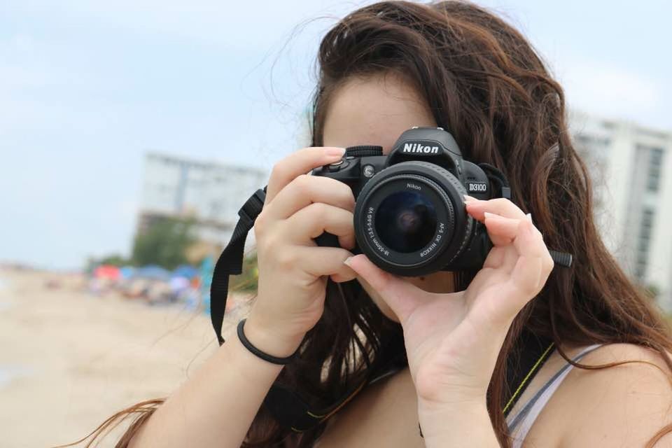 CLOSE-UP PORTRAIT OF WOMAN PHOTOGRAPHING