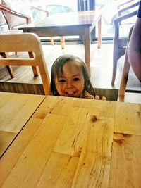 Portrait of smiling boy on table