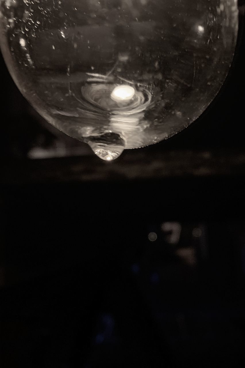 CLOSE-UP OF WATER DROPS ON GLASS AGAINST SKY