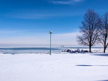 Snow covered field against sky