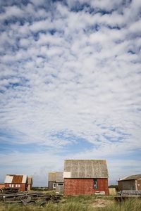 Houses on field against sky