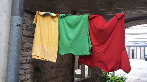 Clothes drying on clothesline against building