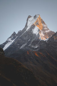 Scenic view of snowcapped mountains against clear sky