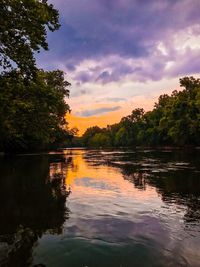 Scenic view of lake against sky at sunset