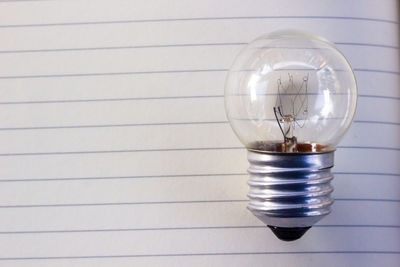 Close-up of light bulb on table