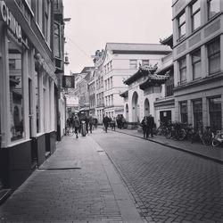 People on street in city against clear sky