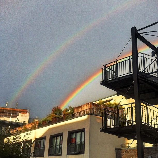 architecture, built structure, building exterior, rainbow, sky, low angle view, house, residential building, residential structure, multi colored, city, cloud - sky, sunset, building, outdoors, illuminated, no people, dusk, nature, copy space