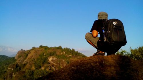 Man standing on landscape against sky