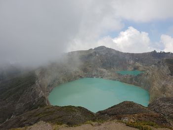 Scenic view of hot springs and mountains against sky