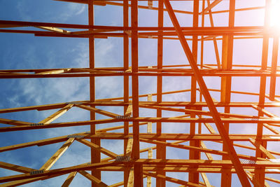 Low angle view of roof beam against sky