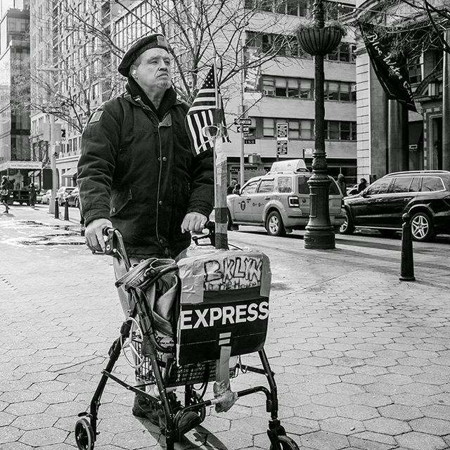 building exterior, city, street, land vehicle, transportation, bicycle, architecture, mode of transport, built structure, men, text, city life, lifestyles, full length, car, western script, communication, city street