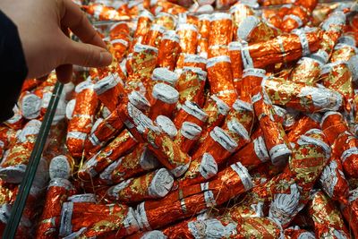 Cropped hand holding candy at store