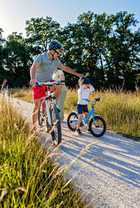 Boy riding bicycle on field