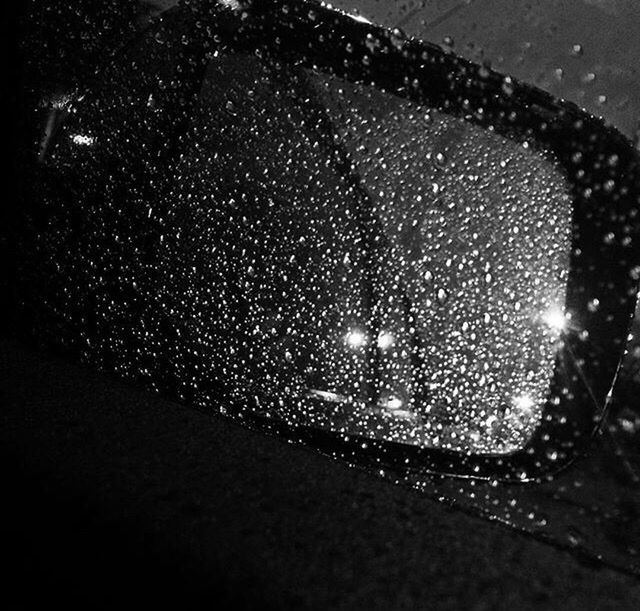 indoors, glass - material, close-up, transparent, illuminated, wet, night, drop, rain, window, lighting equipment, car, glass, no people, focus on foreground, street, raindrop, water, transportation, reflection