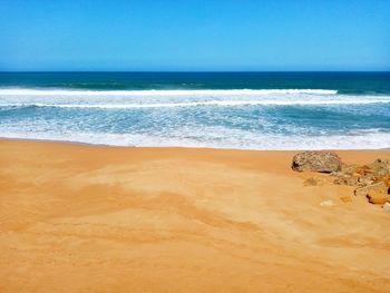 Scenic view of beach against clear sky
