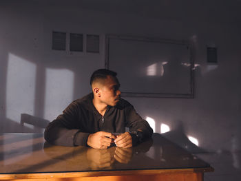 Man sitting on table at home