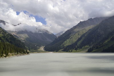 Scenic view of mountains against cloudy sky