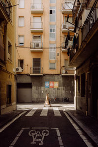 Side view of woman walking on street in city