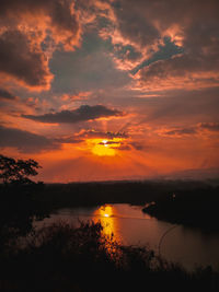 Scenic view of lake against romantic sky at sunset