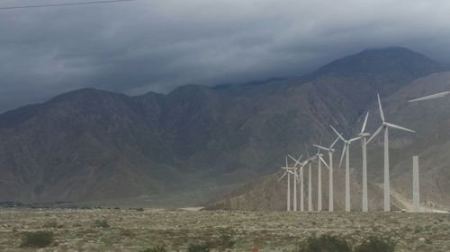 Scenic view of mountains against cloudy sky