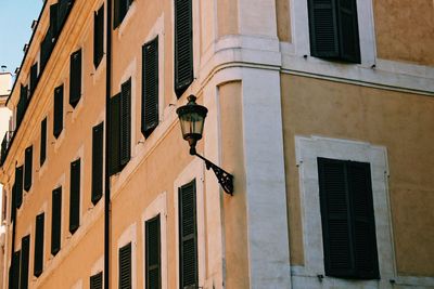 Low angle view of street light against building