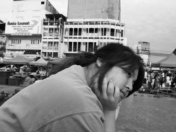 Portrait of man on street against buildings in city