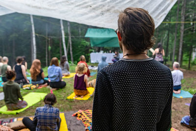 Rear view of people standing outdoors