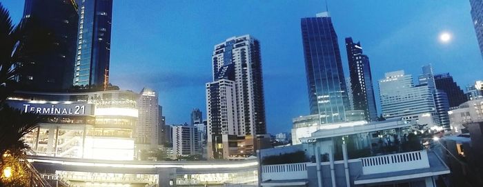 Low angle view of modern buildings against blue sky