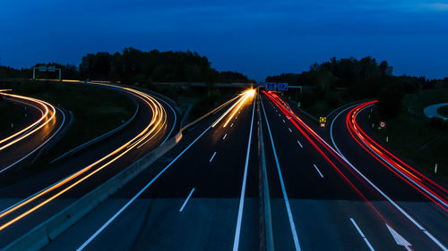 High angle view of light trails on highway at night