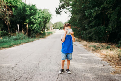 Full length portrait of boy on road