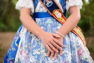 Midsection of woman standing outdoors