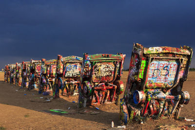 Graffiti on display at beach against sky