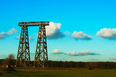 Low angle view of communications tower against sky