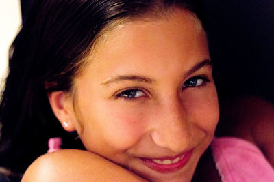 Close-up portrait of smiling young woman