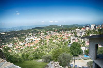 High angle view of town by sea against clear sky