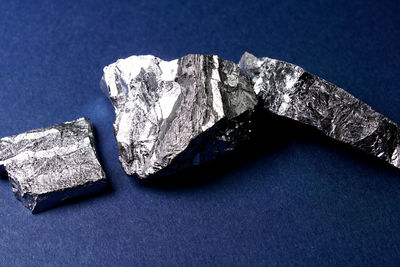 High angle view of rocks against blue background