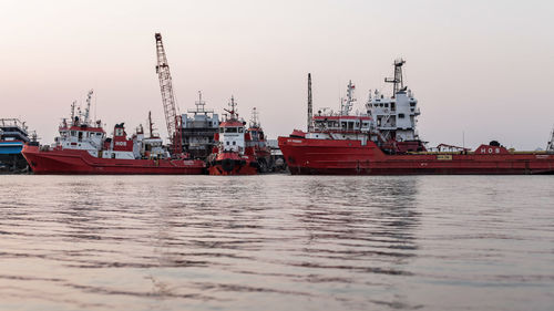 Ship moored at harbor against clear sky