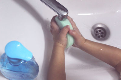 Midsection of woman in bathroom at home