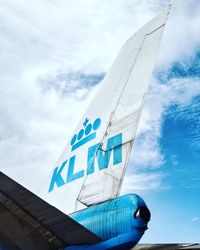 Low angle view of airplane flying against sky